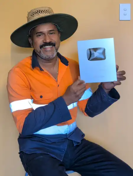 Binu Vadakkedath, creator of Australian Jeevitham, holding his YouTube 100K Silver Play Button award